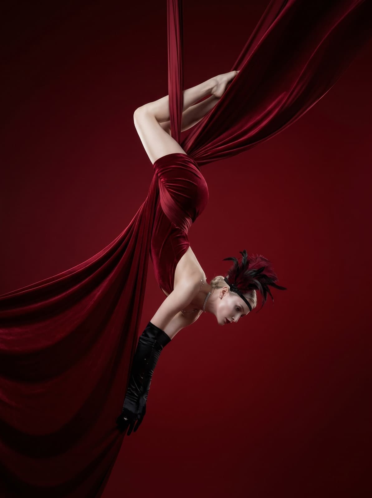 Aerial cabaret performer in red silk